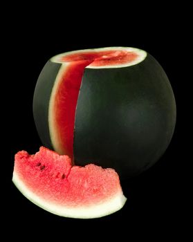 Ripe watermelon with cut piece of watermelon on black background isolated