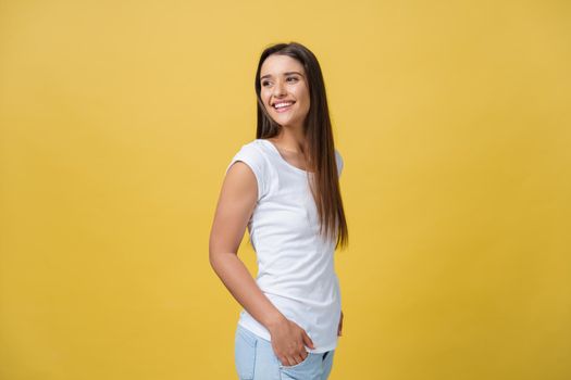 Portrait young beautiful caucasian girl with an white shirt laughing over yellow background.