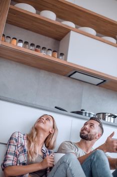 young couple looking at their new kitchen shelf