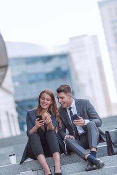 young business couple making online order sitting on the street. photo with copy space