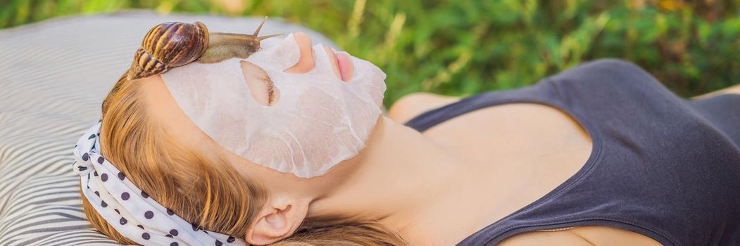 Young woman makes a face mask with snail mucus. Snail crawling on a face mask BANNER, LONG FORMAT