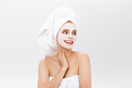 Beautiful woman with facial mask on white background