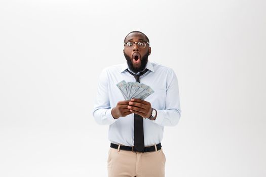 African man holding bank notes happy and surprised cheering expressing wow gesture