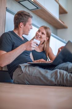 young couple making online order in their new apartment
