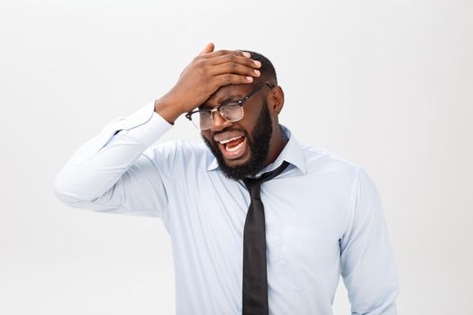 Portrait of desperate annoyed black male screaming in rage and anger tearing his hair out while feeling furious and mad with something. Negative human face expressions, emotions and feelings.