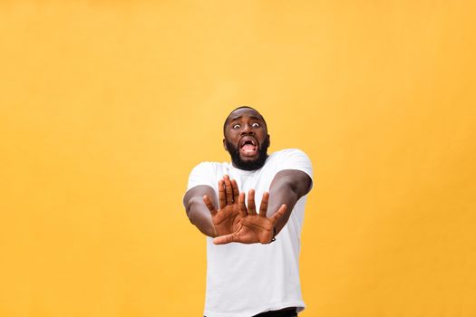 Portrait shock and annoyed displeased young man raising hands up to say no stop right there isolated orange background. Negative human emotion, facial expression, sign, symbol, body language