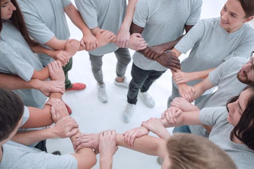 group of like-minded people weaving their hands into a circle