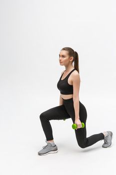 Exercise. Sports Woman In Fashion Sportswear Stretching Legs.