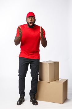 Delivery Concept: Handsome african delivery man shocking facial expression. Isolated over grey background.