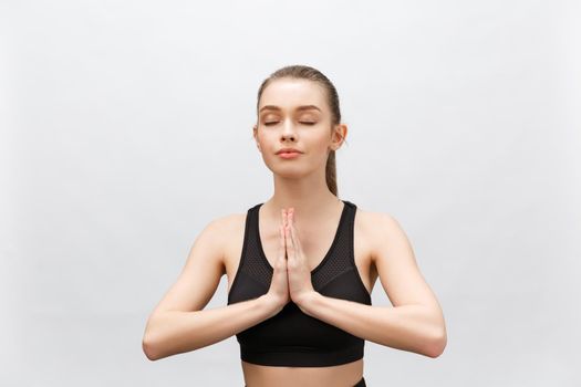 Lotus pose, yoga hands close up. Yoga woman in white sport clothes meditation. Young woman relax and exercising in white class yoga against window. Freedom.