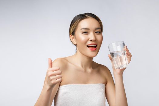 relaxed young smiling woman drinking clean water.