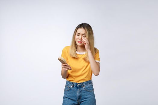 Unhappy Asian girl on the phone , Angry Asian woman talking phone with her boyfriend, isolated on white background.