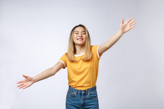 Closeup portrait of pretty young woman motioning with arms to come and give her a bear hug, isolated on white background. Positive emotion facial expression feeling, signs symbols, body language.