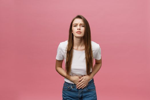 Young caucasian woman over isolated background with hand on stomach because indigestion, painful illness feeling unwell. Ache concept