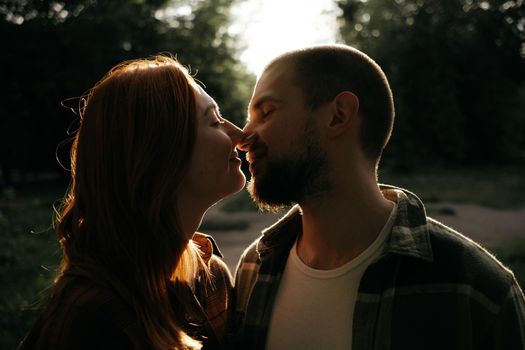 lovers kiss at sunset in the backlight