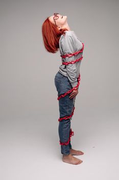 girl entangled in a chain,A red-haired woman with brown hair tries to get rid of the chain