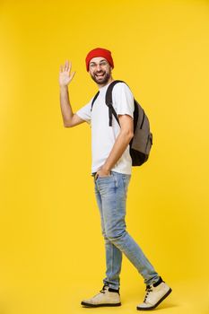 young hipster man wearing hat , suspenders, isolate on yellow background.