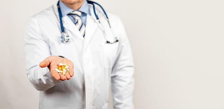 Male doctor suggests taking medicine for health or an antibiotic and painkiller