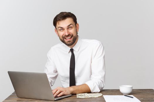 Young businessman in a workplace with surprise and shocked facial expression