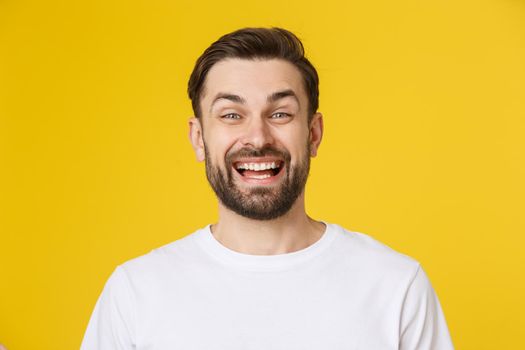 Young casual man portrait isolated on yellow background