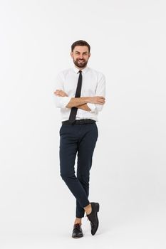 Portrait of a confident young businessman with hands in pockets on white background