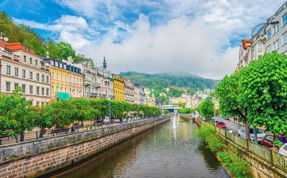 Karlovy Vary historical city centre with Tepla river pedestrian embankment, colorful beautiful buildings