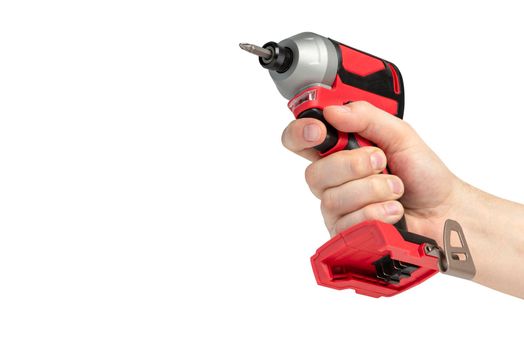 Drill in hand on a white isolated background. Cordless drill or screwdriver in a male hand. Removable lithium battery casts a shadow. The concept of selling and using cordless tools.