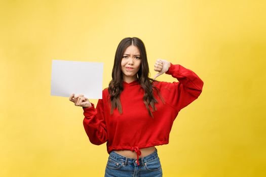 Young adult woman holding blank paper sheet over isolated background stressed, shocked with shame and surprise face, angry and frustrated. Fear and upset