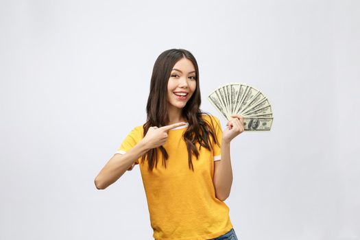 Closeup portrait of beautiful asian woman holding money isolated on white background. Asian girl counting her salary dollar note. Success wealth financial business cashflow currency payment concept