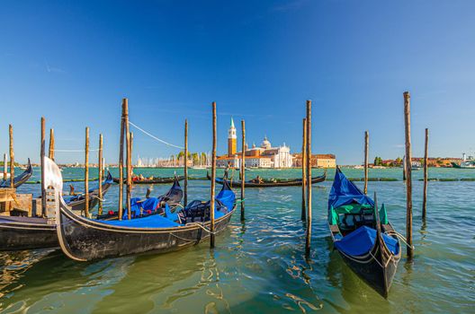 Gondolas moored docked on water in Venice