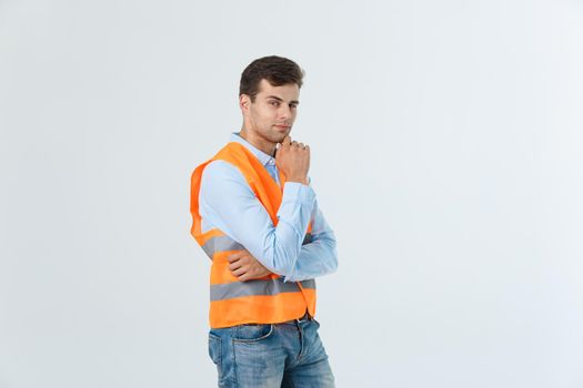 Visionary architect or engineer looking up and thinking about new projects. Wearing reflective vest isolated on white background.