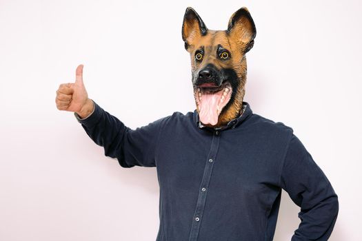 person with a dog mask with the thumb up
