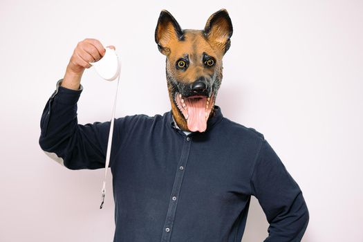 person with dog mask shows a walking leash