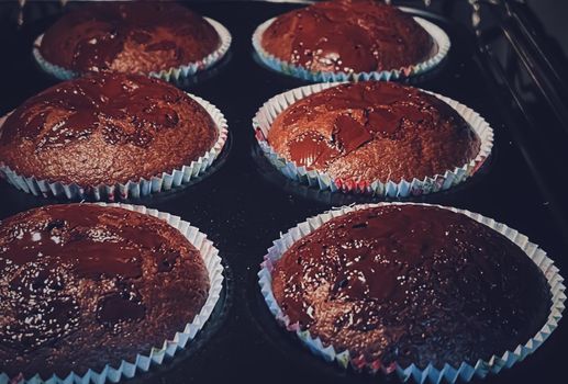 Chocolate muffins baking in the oven, homemade cakes recipe, food and cooking