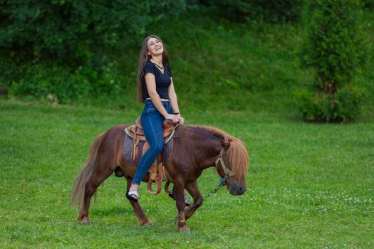 girl riding a pony
