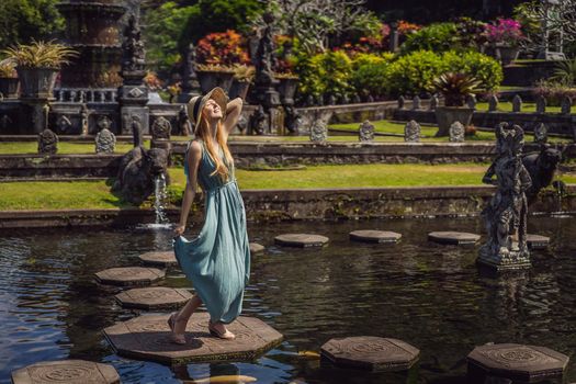 Young woman tourist in Taman Tirtagangga, Water palace, Water park, Bali Indonesia