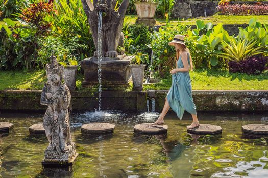 Young woman tourist in Taman Tirtagangga, Water palace, Water park, Bali Indonesia