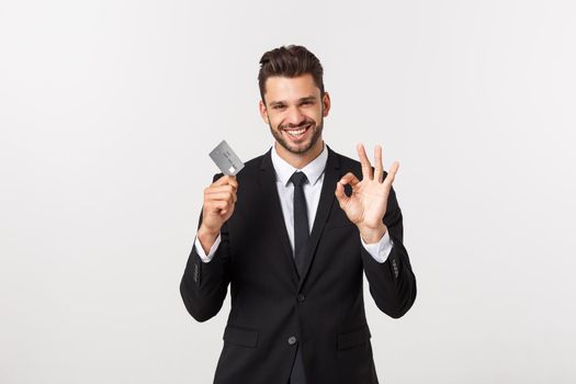 Surprised, speechless and impressed handsome caucasian businessman in classic suit showing credit card, say wow, standing white background astonished