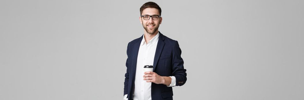 Portrait of a handsome businessman in eyeglasses with a cup of coffee.