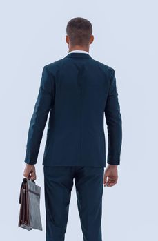 rear view.confident businessman with briefcase