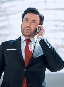 serious businessman talking on a mobile phone