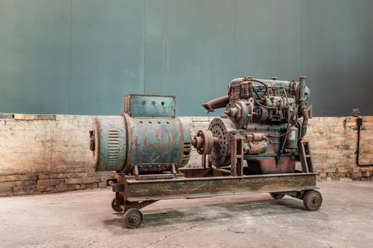 Vintage large diesel engine in the warehouse of factory.