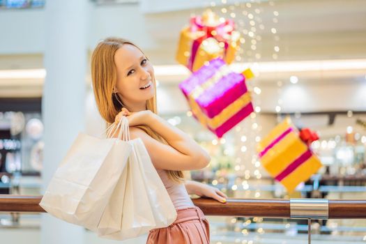 Young woman with purchases in new year shop. Christmas sale, black friday
