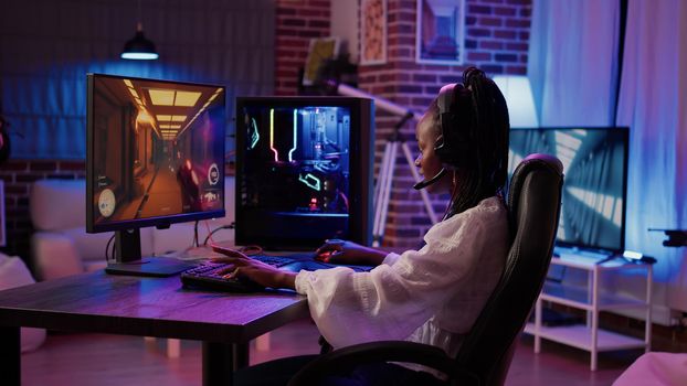 African american gamer girl streaming first person shooter tournament surprised after winning online competition