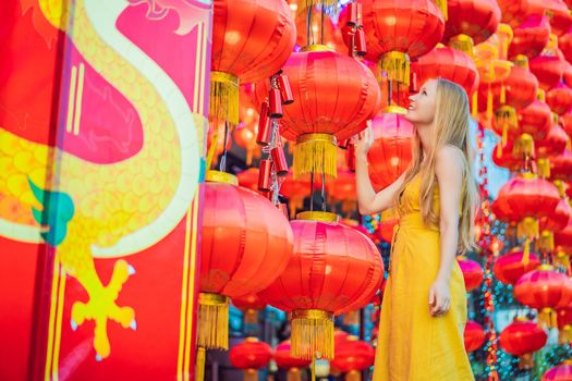 Woman celebrate Chinese New Year look at Chinese red lanterns. Chinese lanterns