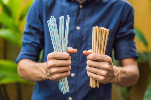 paper and plastic drinking straws in hands