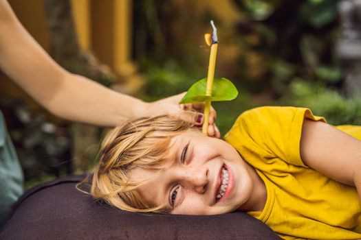 The boy gets a procedure with an ear candle, children's ears health, good hearing, earwax