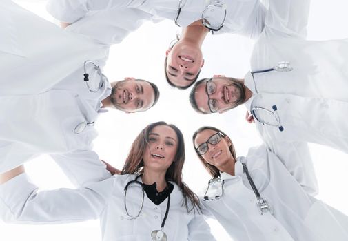 group of diverse medical staff standing in a circle.