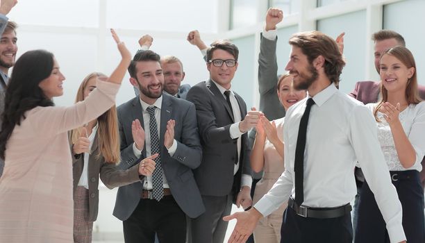 corporate group of employees congratulating each other on the victory