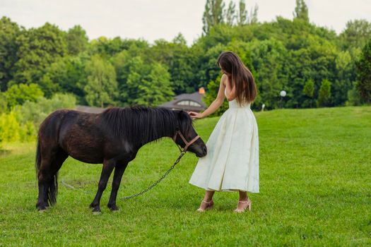 girl next to pony